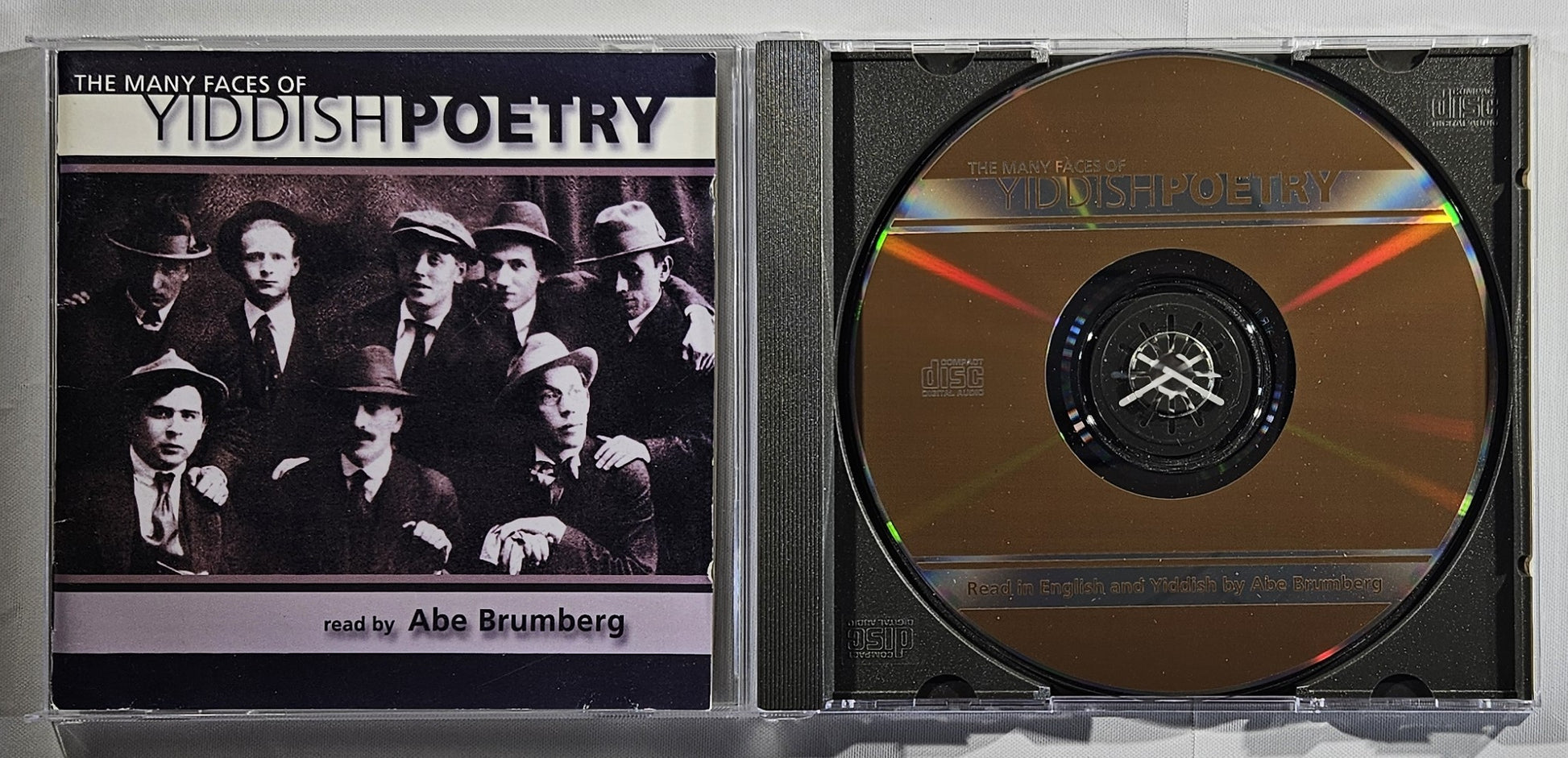 CD case with Yiddish poetry cover featuring a group of men and a gold CD inside.