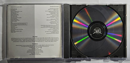 CD with rainbow gradient and text on a reflective surface